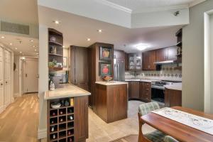 a large kitchen with wooden cabinets and a table at Saint Sauveur Dream in Saint-Sauveur-des-Monts