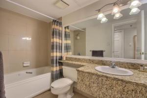 a bathroom with a sink and a toilet and a mirror at Saint Sauveur Dream in Saint-Sauveur-des-Monts +11 photos
