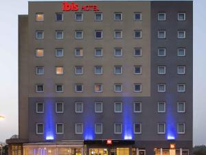 a building with blue lights on the side of it at ibis Luxembourg Sud in Livange