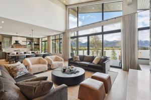 a living room with couches and a table at Sisu Lodge by Canmore Premier in Kananaskis Village