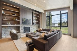 a living room with a couch and a fireplace at Sisu Lodge by Canmore Premier in Kananaskis Village