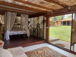 a screened in porch with a view of a yard at Terra Lodge in Ericeira +137 photos