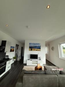 a living room with a couch and a flat screen tv at Apartment Spitzenblick in Angerberg