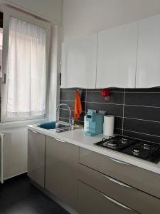 a kitchen with a sink and a stove at Gerenz-home in Lecco