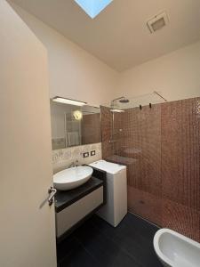 a bathroom with a sink and a shower at Gerenz-home in Lecco +7 photos