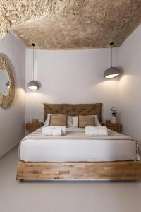 a bedroom with a large bed with two pillows at Begani63 Boutique Apartments in Gaeta