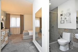 a bathroom with a toilet and a sink and a shower at In City Hotel in Yerevan