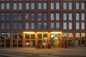 a building with a lot of windows on a street at Aloft by Marriott Strasbourg City Centre in Strasbourg