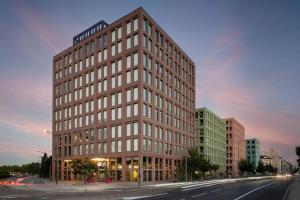 a rendering of a tall building on a city street at Aloft by Marriott Strasbourg City Centre in Strasbourg