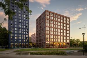 two tall buildings sitting next to each other at Aloft by Marriott Strasbourg City Centre in Strasbourg