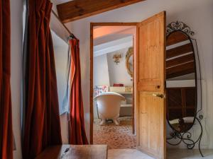 a bathroom with a bath tub and a mirror at C'AN Sabuba in Deia +17 photos