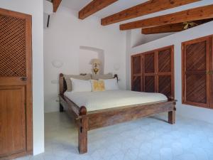 a bedroom with a wooden bed in a room at C'AN Sabuba in Deia