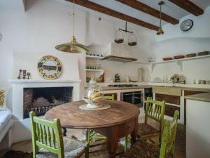 a kitchen with a table and chairs and a fireplace at C'AN Sabuba in Deia