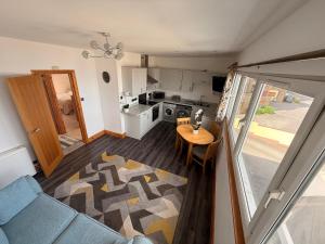 a small kitchen with a table and a dining room at Flat White in Westward Ho