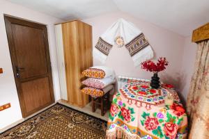 a bedroom with a bed and a chair and a door at Cabana Colț de liniste in Feldru