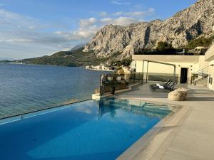 a swimming pool with a view of the water at ADRIA MIRIS apartments in Drasnice