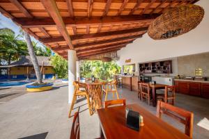 an open kitchen and living room with a wooden ceiling at Hotel Meson de Mita in Punta Mita +68 photos
