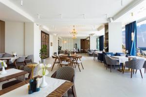 a dining room with tables and chairs and a restaurant at Boutique Hotel Portofino in Odesa