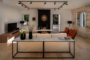 a living room with a couch and a table at Old Town Oasis in Dubrovnik