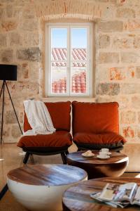 a living room with a couch and a window at Old Town Oasis in Dubrovnik +6 photos