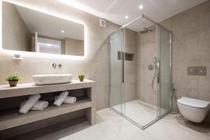 a bathroom with a sink and a shower at Sandy Pines Villas in Alykes +80 photos