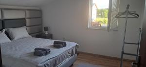 a bedroom with a bed with two bags on it at LUX APARTMENT in Banja Luka