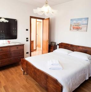 a bedroom with a large bed and a television at Casa Il Sogno in Vazzola