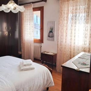 a bedroom with a white bed and a window at Casa Il Sogno in Vazzola +5 photos