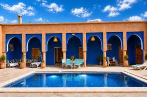 a villa with a swimming pool and a patio at Kasbah ben hamou in Nkob +31 photos