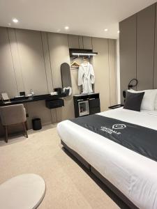 a hotel room with a bed and a dressing room at Centrale Hotel in Tirana