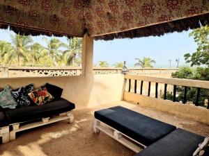 a porch with a couch and a view of the beach at Beach House in Saly Portudal