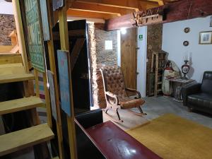 a living room with a chair and a couch at Casa do Baloiço em Porto de Vacas Aldeias de Xisto in Janeiro de Baixo +19 photos