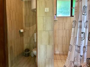 a bathroom with a shower curtain and a toilet at Camping Lukač in Kutina +34 photos
