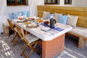 a table with food on it on a patio at El Fresquedal in Alozaina