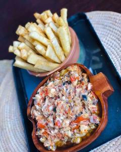 a bowl of coleslaw and a plate of french fries at Emglo Suite in Lagos
