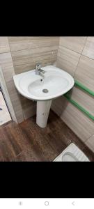 a bathroom with a white sink in a room at Hostel Sherifaj in Valbonë