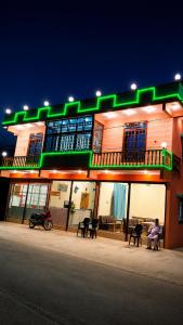 a building with green lights on the side of it at Rayn Basayra Kashmir in Bāta