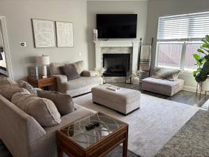 a living room with a couch and a fireplace at NWA Modern Stay in Springdale