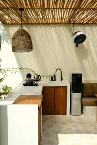 a kitchen with a sink and a refrigerator at Promo - Private 1BR villa for couples in Kuta Lombok