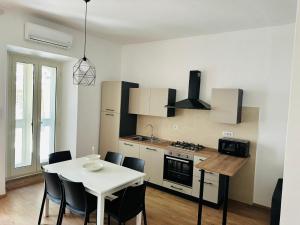 a kitchen with a table and a white table and chairs at Casa Lucia in Marta