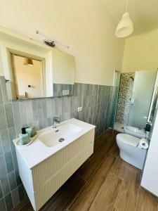 a bathroom with a sink and a toilet at Casa Lucia in Marta +7 photos