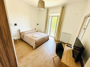 a bedroom with a bed and a desk and a chair at Casa Lucia in Marta