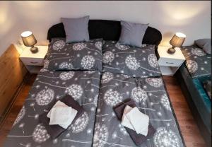 a large bed in a room with two lamps at NiKi in Patince +16 photos