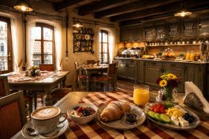 a kitchen with a table with a plate of food at Albert Authentic Suites Brasov - Tampa View - Preferred Spa Rates & Exclusive Guest Benefits in Braşov