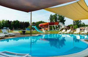 a pool with a slide and a water park at NiKi in Patince