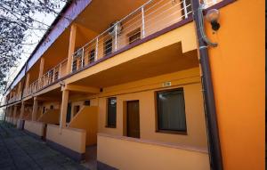 an orange building with balconies on the side of it at NiKi in Patince