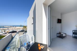 a balcony with a view of the beach at Sea View Hotel Fronte Mare in San Vito lo Capo
