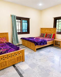 two beds in a room with purple sheets at Rayn Basayra Kashmir in Bāta +25 photos