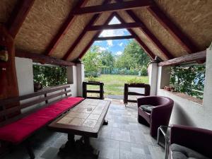 a porch with a bed and a table and chairs at Camping Lukač in Kutina