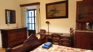 a bedroom with a bed and a desk and a dresser at Ca na Pereta in Sencelles